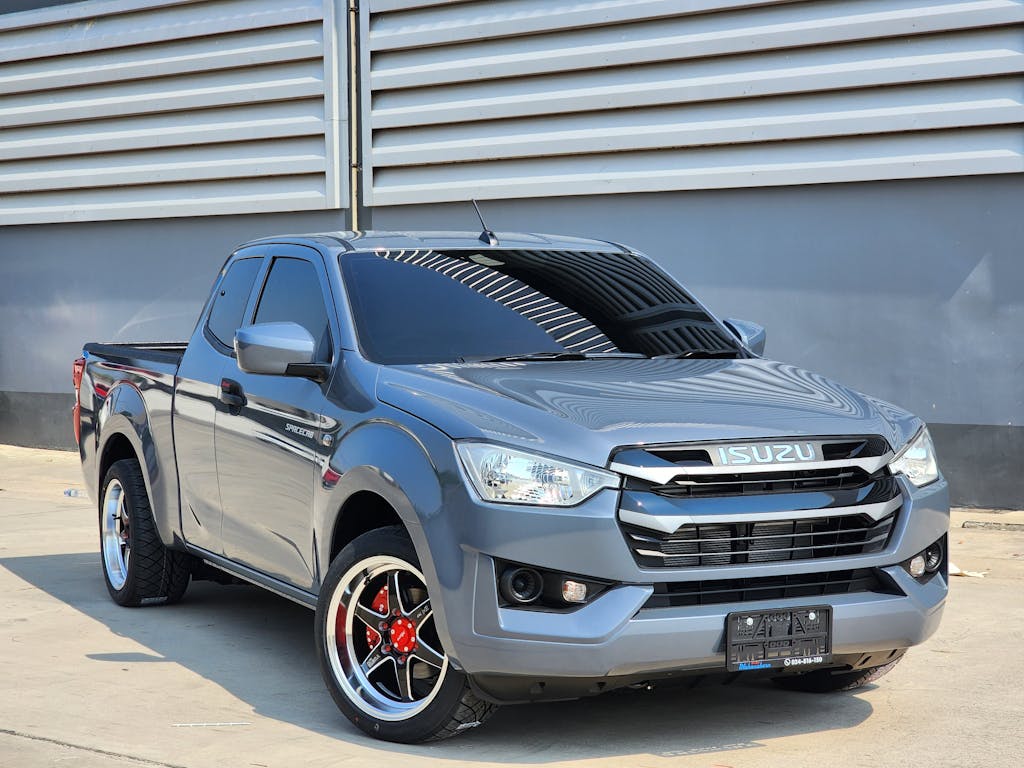 A modern gray pickup truck displayed outdoors with stylish alloy wheels.